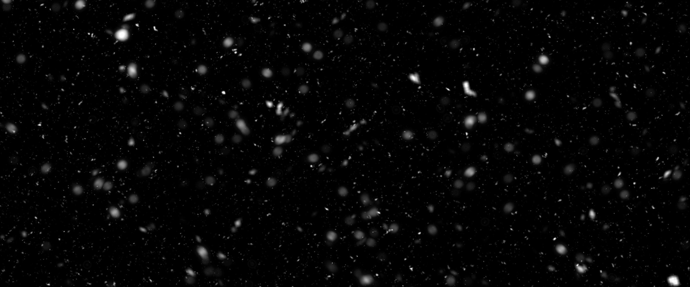 Different realistic falling snow or snowflakes. Falling snow isolated on black background. Winter snowfall illustration. Bokeh lights on black background, flying snowflakes in the air. Snow at night. photo