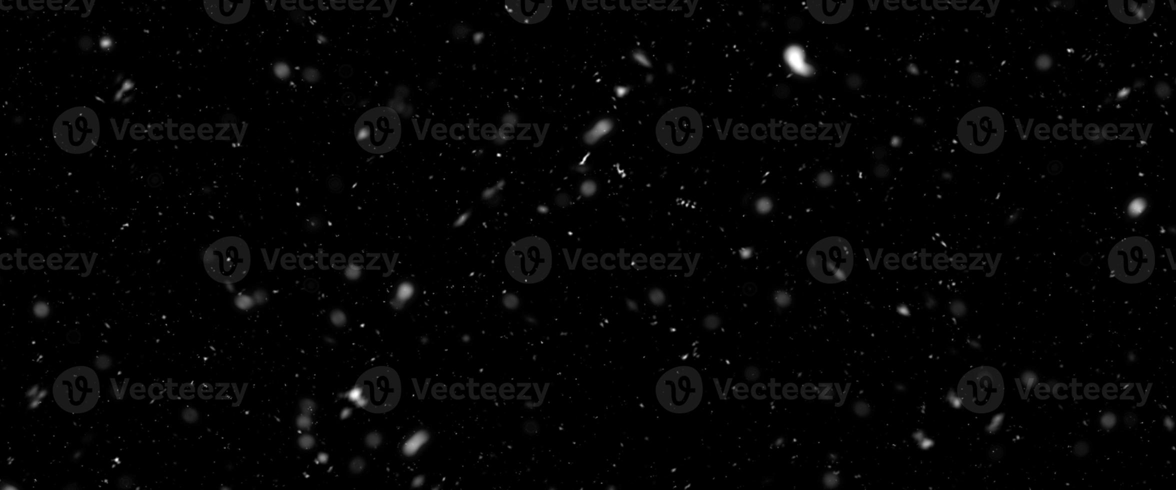 Snowfall bokeh on black background. Many snowflakes in flying in the air. Winte night snowfall and blizzard of snow at. Blur bokeh light effect creative background photo