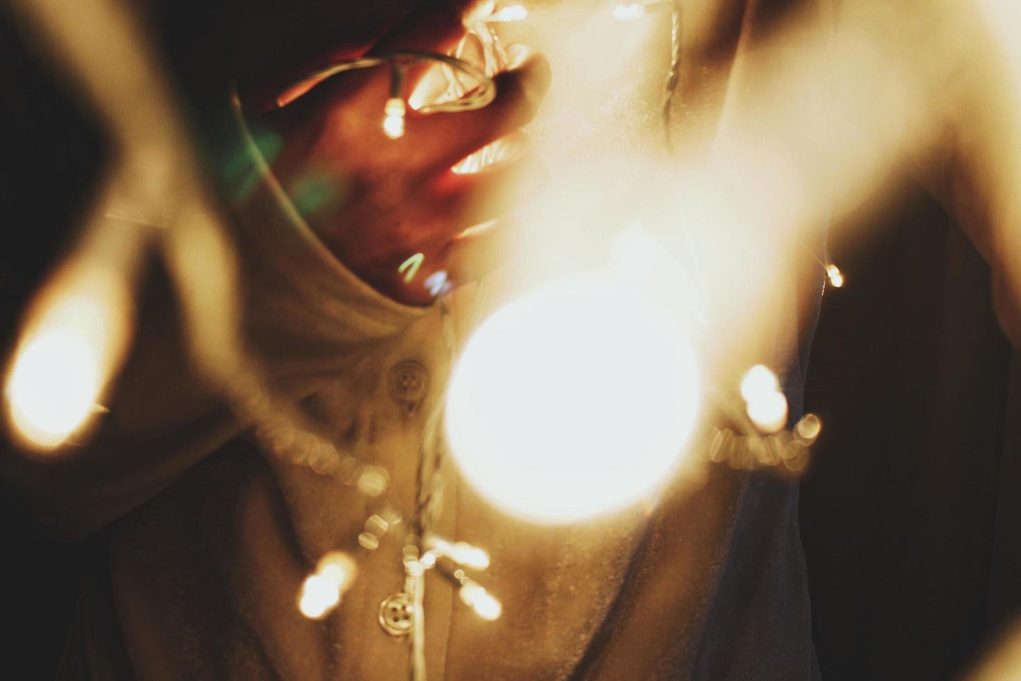 Woman holding fairy lights photo