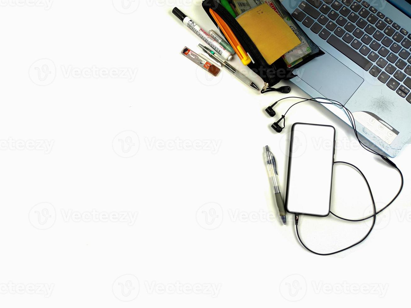 Flat lay,background mockup. the workspace in the background of the desk is white from the top view. layout space with mobile phones, laptop, books, pencils, stationery on a white desk background. photo
