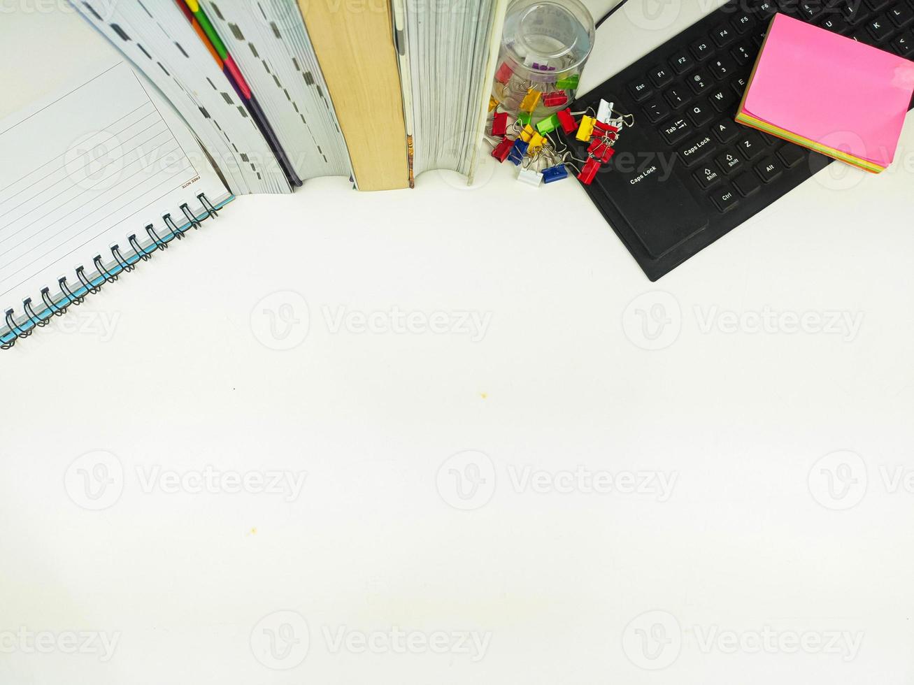 Flat lay, white desk in the office with layout space.with office equipment such as pencils, notebooks and keyboards at the top.mock up table photo