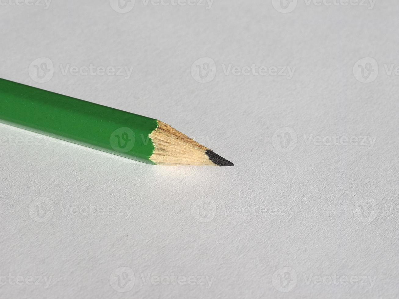 green pencil on paper sheet photo