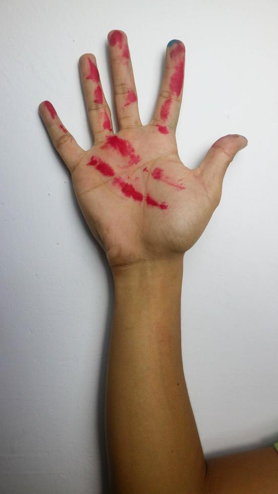 hand with red ink on a white background photo