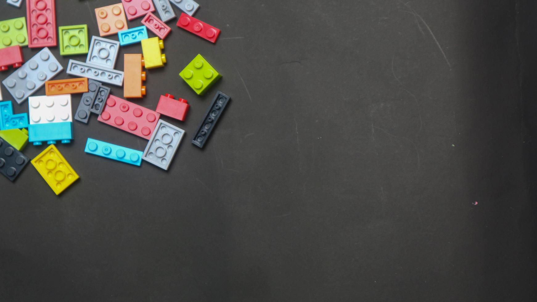 Plastic toy block on a black background photo