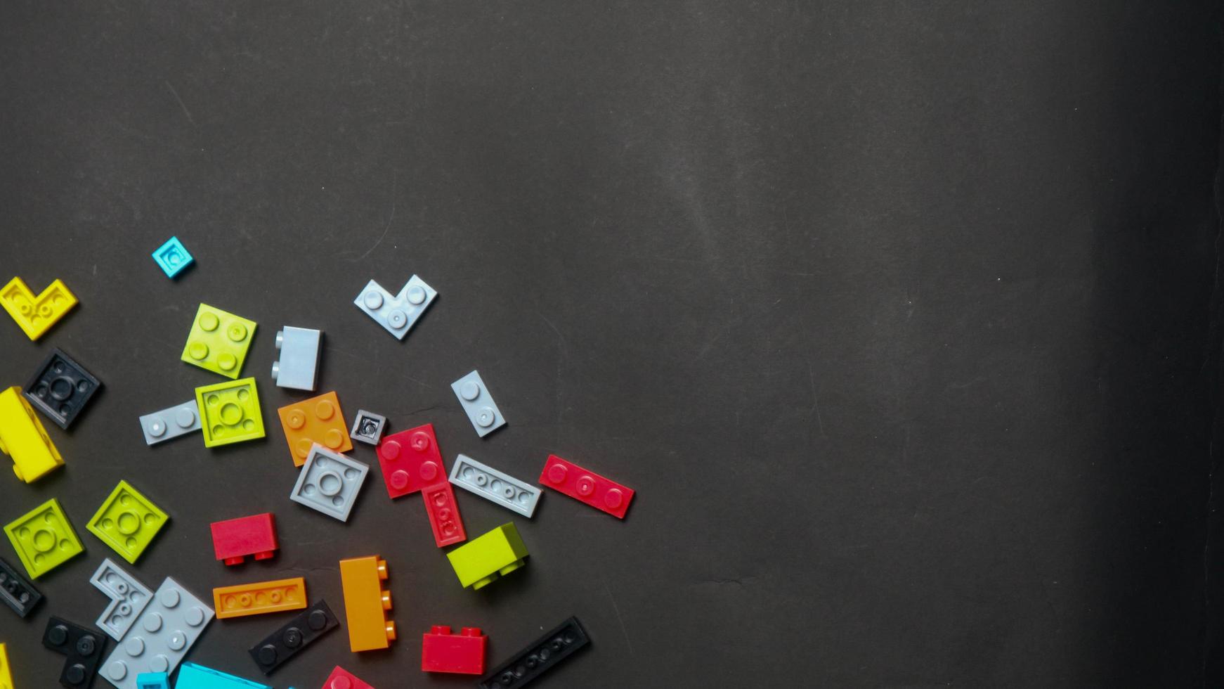 Plastic toy block on a black background photo