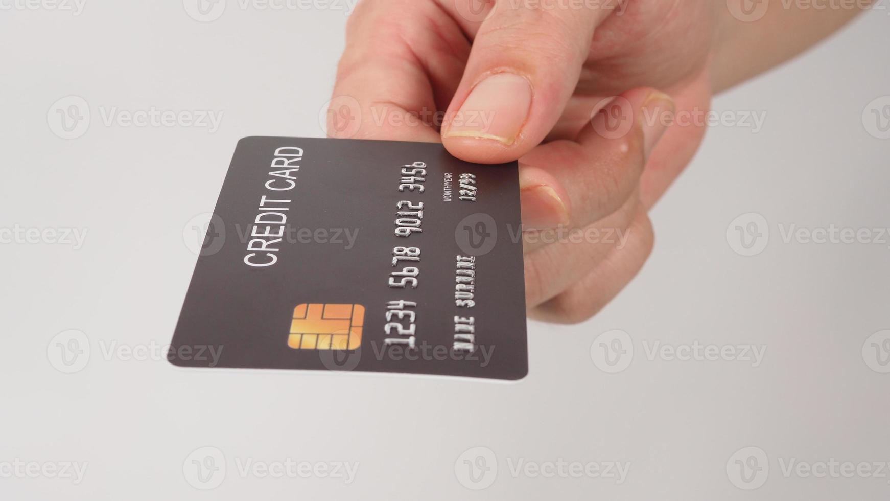 Black credit card in hand isolated on white background. photo