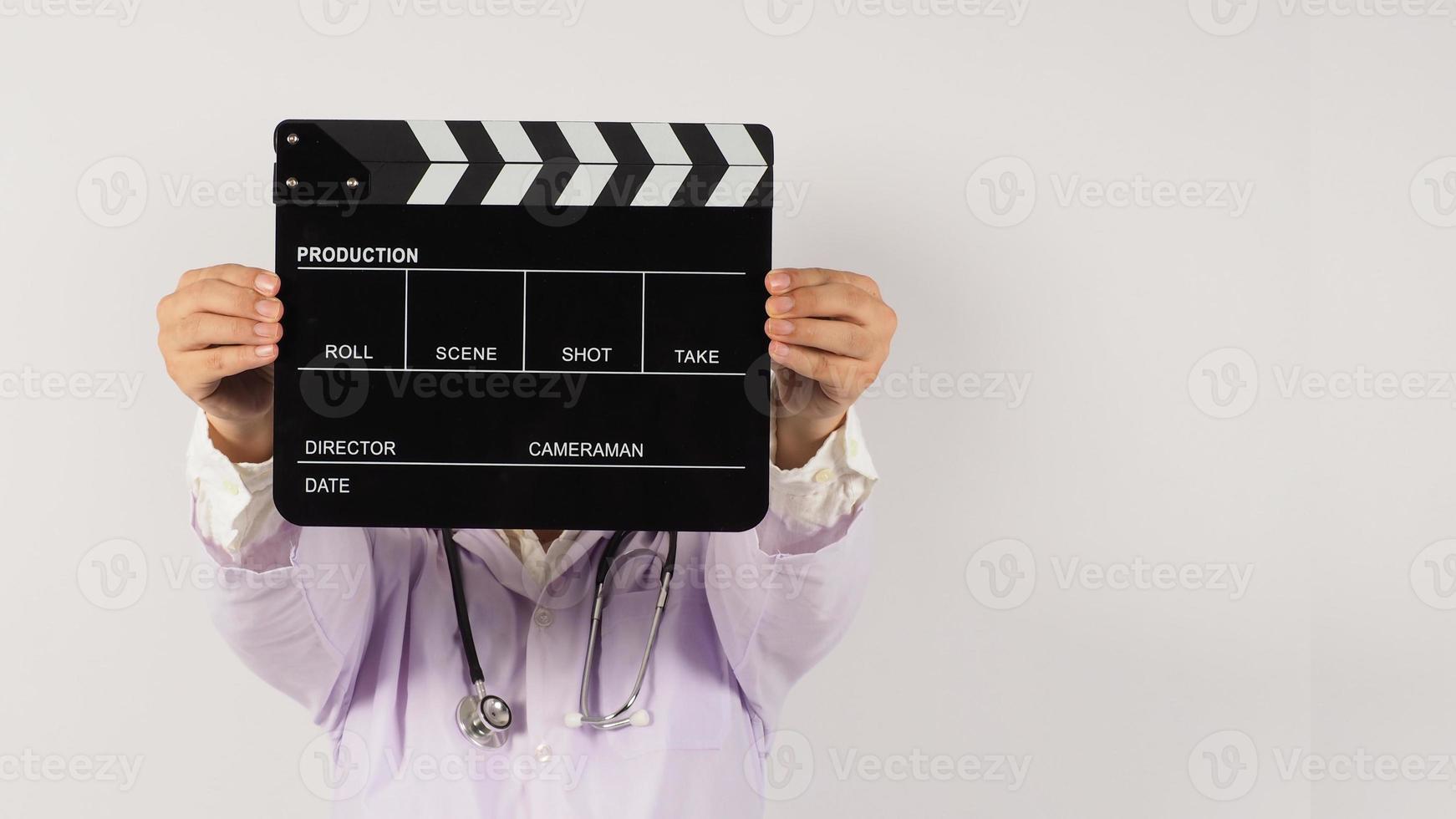 Doctor's holding Black Clapper board in hand on white background. Studio shooting. photo