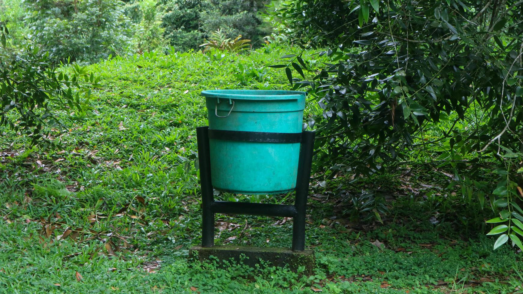 green trash can in tourist spot photo