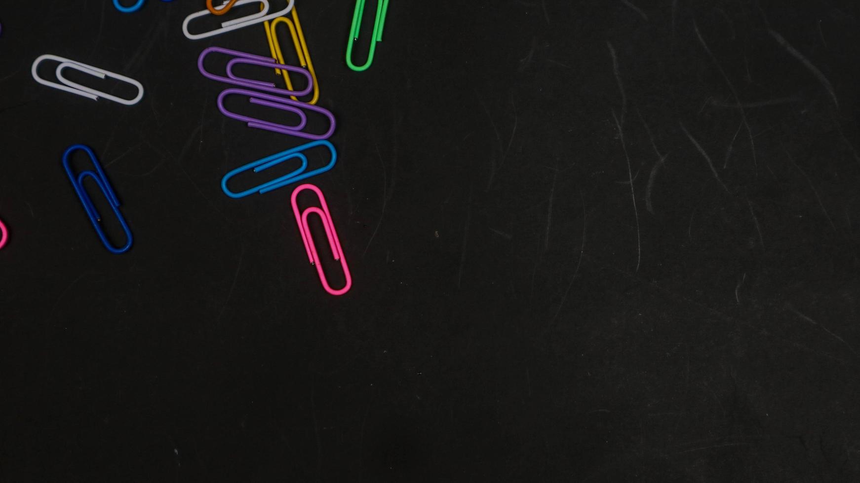 Paper clip isolated on a black background photo