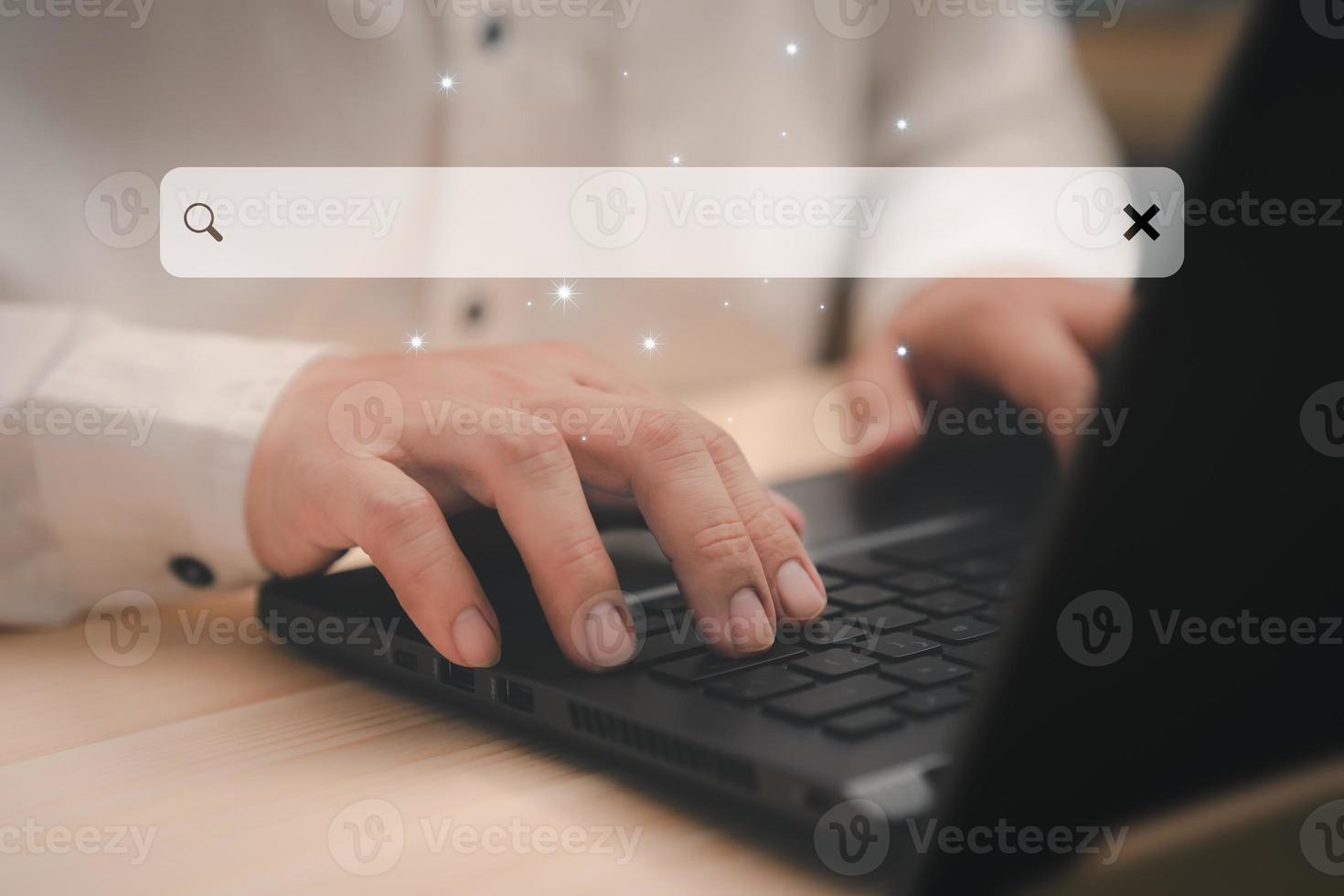 Businessman's hand working with computer laptop on desk in home. Searching Browsing Internet Data Information with blank search bar. Search Engine Optimization SEO Networking Concept. photo