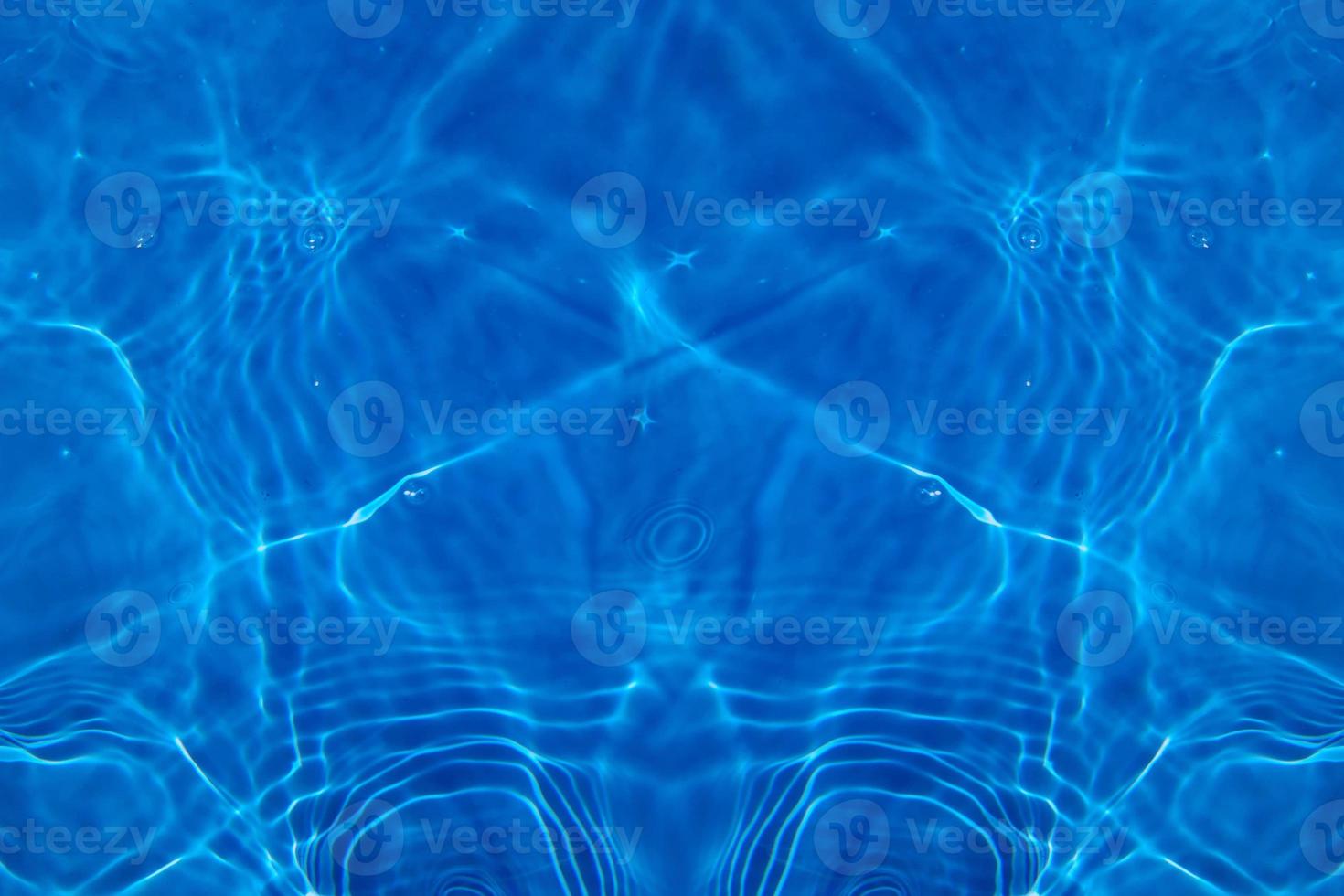 Defocus blurred transparent blue colored clear calm water surface texture with splashes and bubbles. Trendy abstract nature background. Water waves in sunlight with copy space. Blue watercolor shining photo