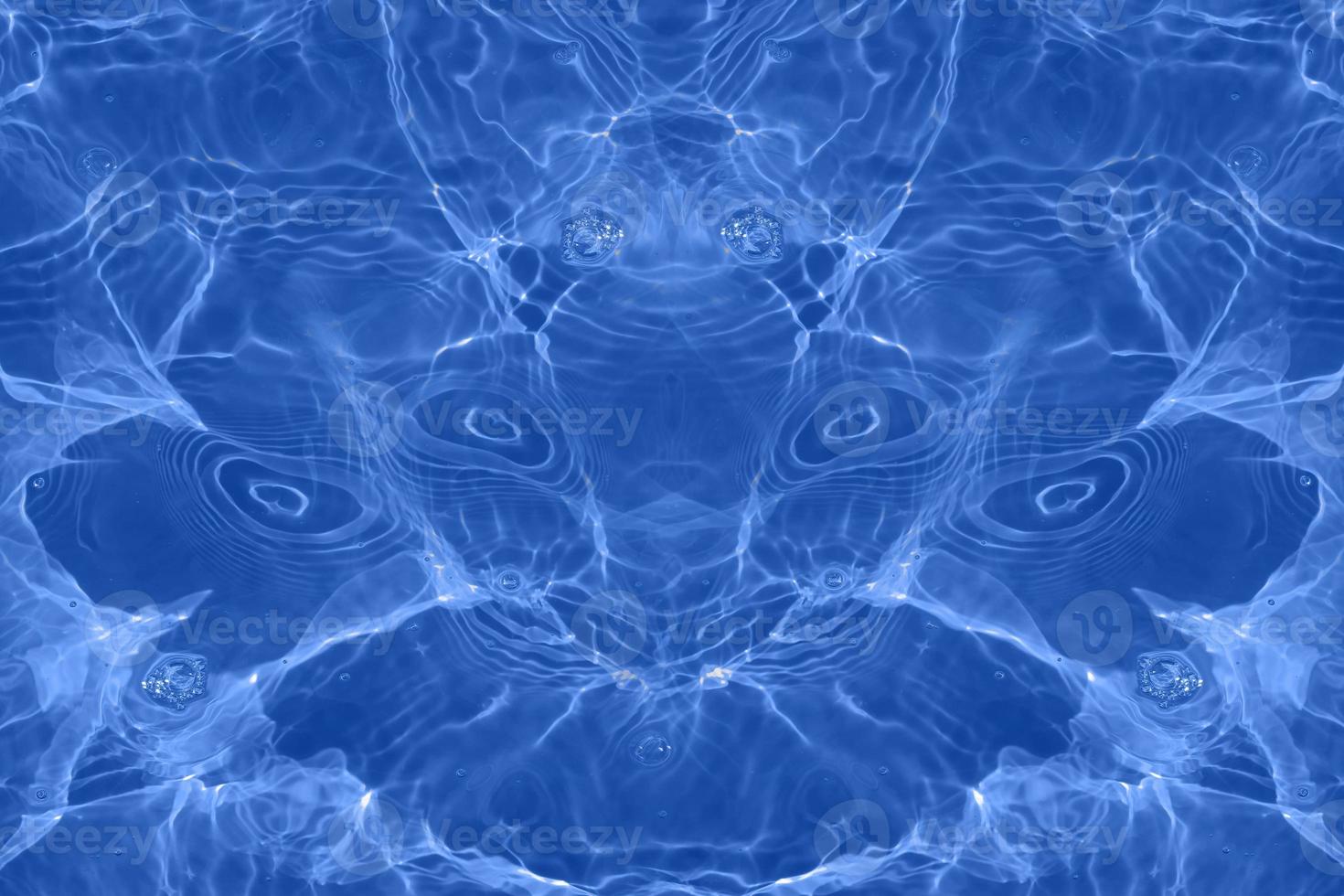 Defocus blurred transparent blue colored clear calm water surface texture with splashes and bubbles. Trendy abstract nature background. Water waves in sunlight with copy space. Blue watercolor shining photo
