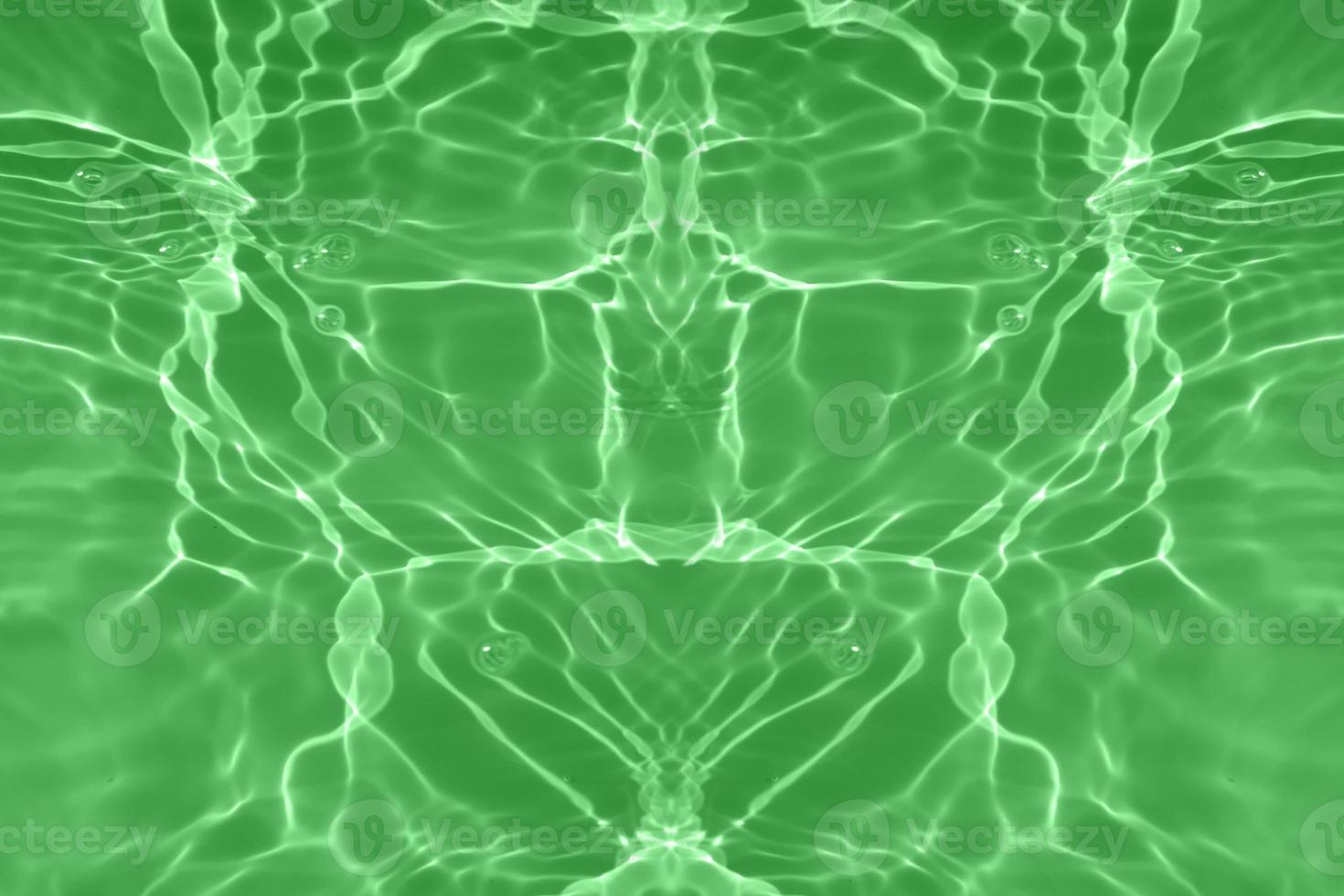 Defocus blurred transparent green colored clear calm water surface texture with splashes and bubbles. Trendy abstract nature background. Water waves in sunlight with copy space. Green water shining. photo