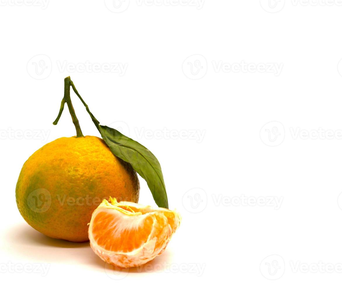 Tangerine with leaves and a slice of tangerine. photo