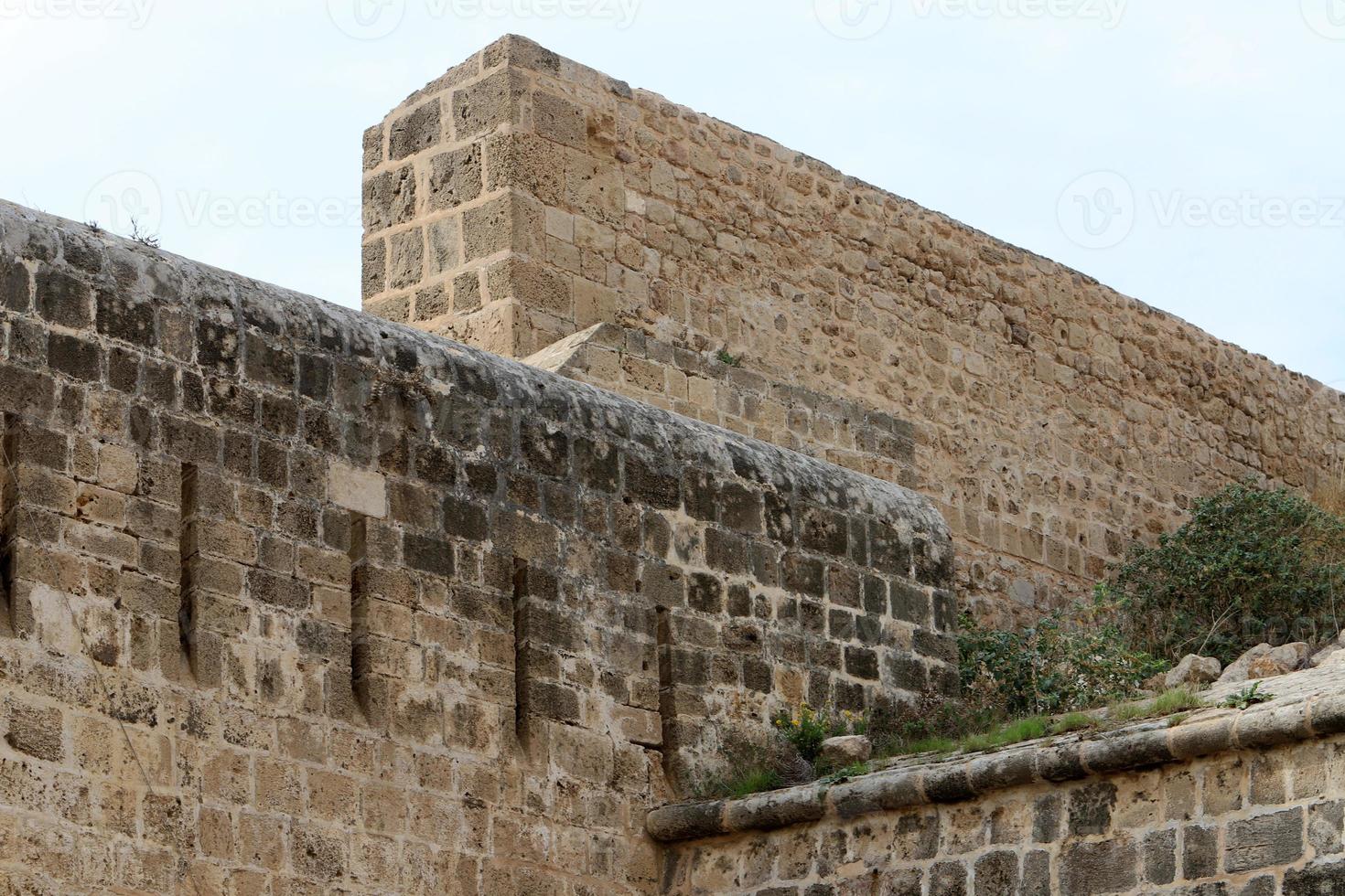 Stone wall of an ancient fortress on the seashore in Israel. photo