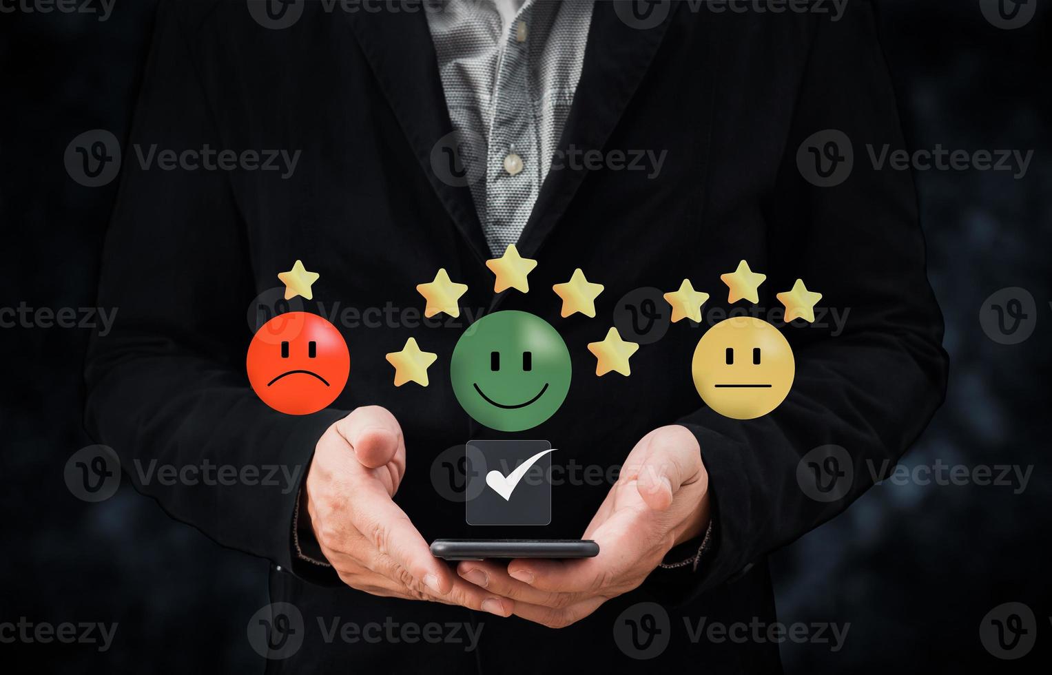 person hand using smartphone give happy smile icon and five star symbol to increase rating of product and service concept, Customer service experience and business satisfaction survey. photo