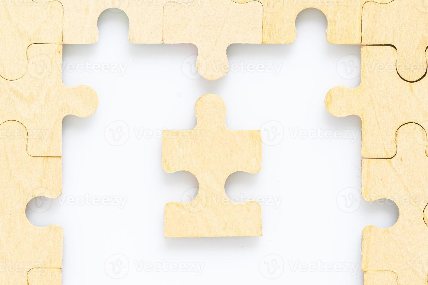 wooden jigsaw puzzle pieces on white background photo