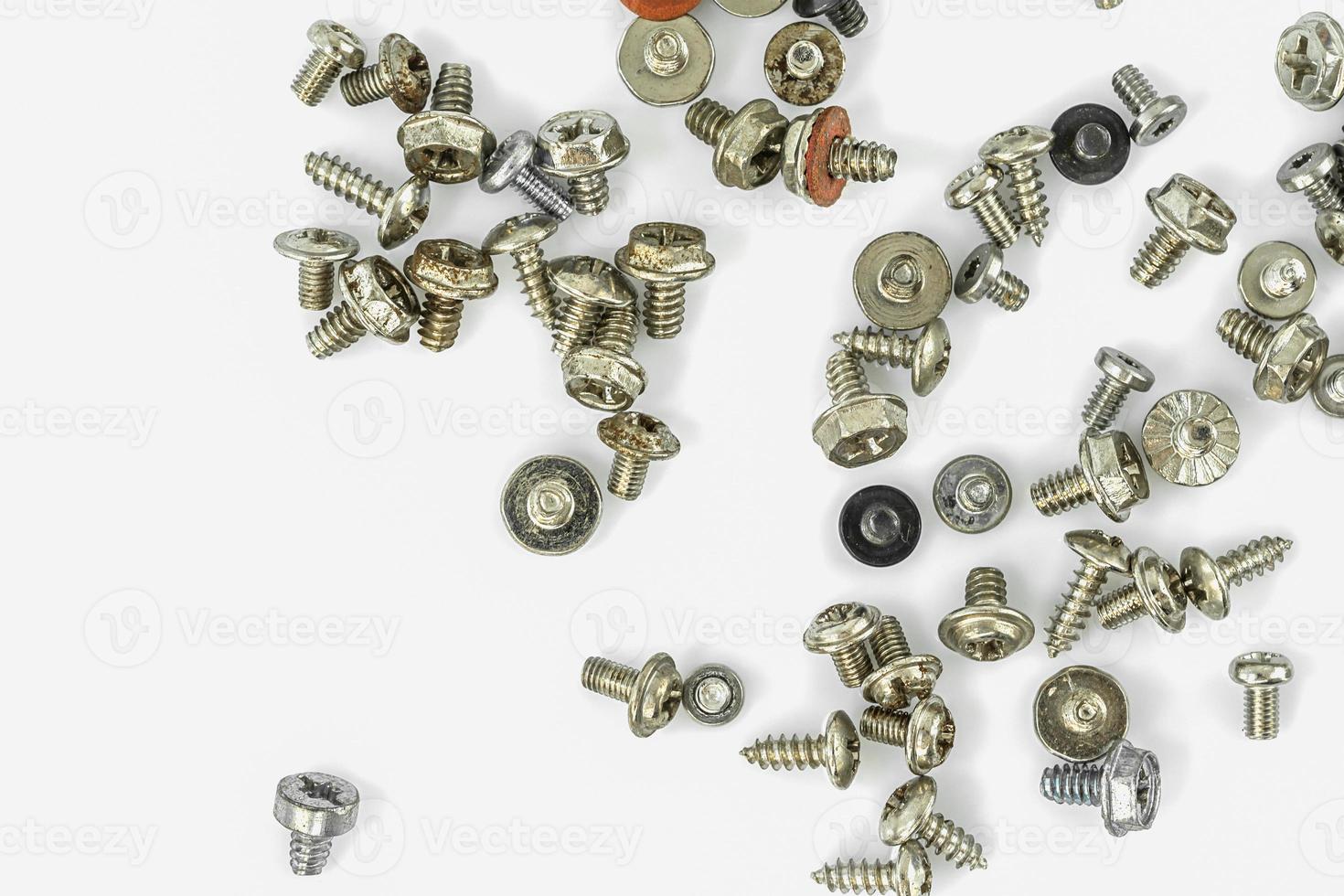 Old screws on the white background photo