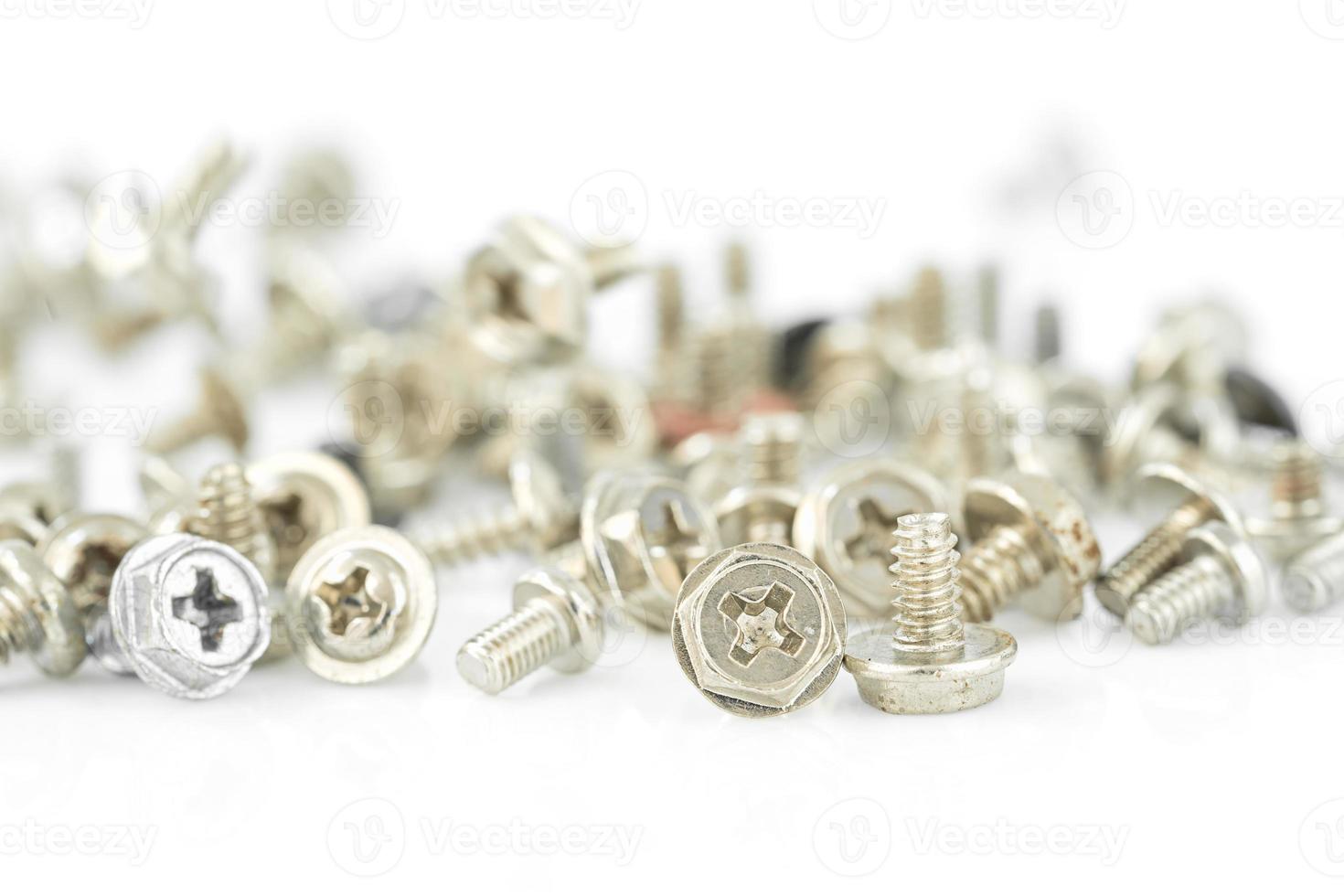 Old screws on the white background photo
