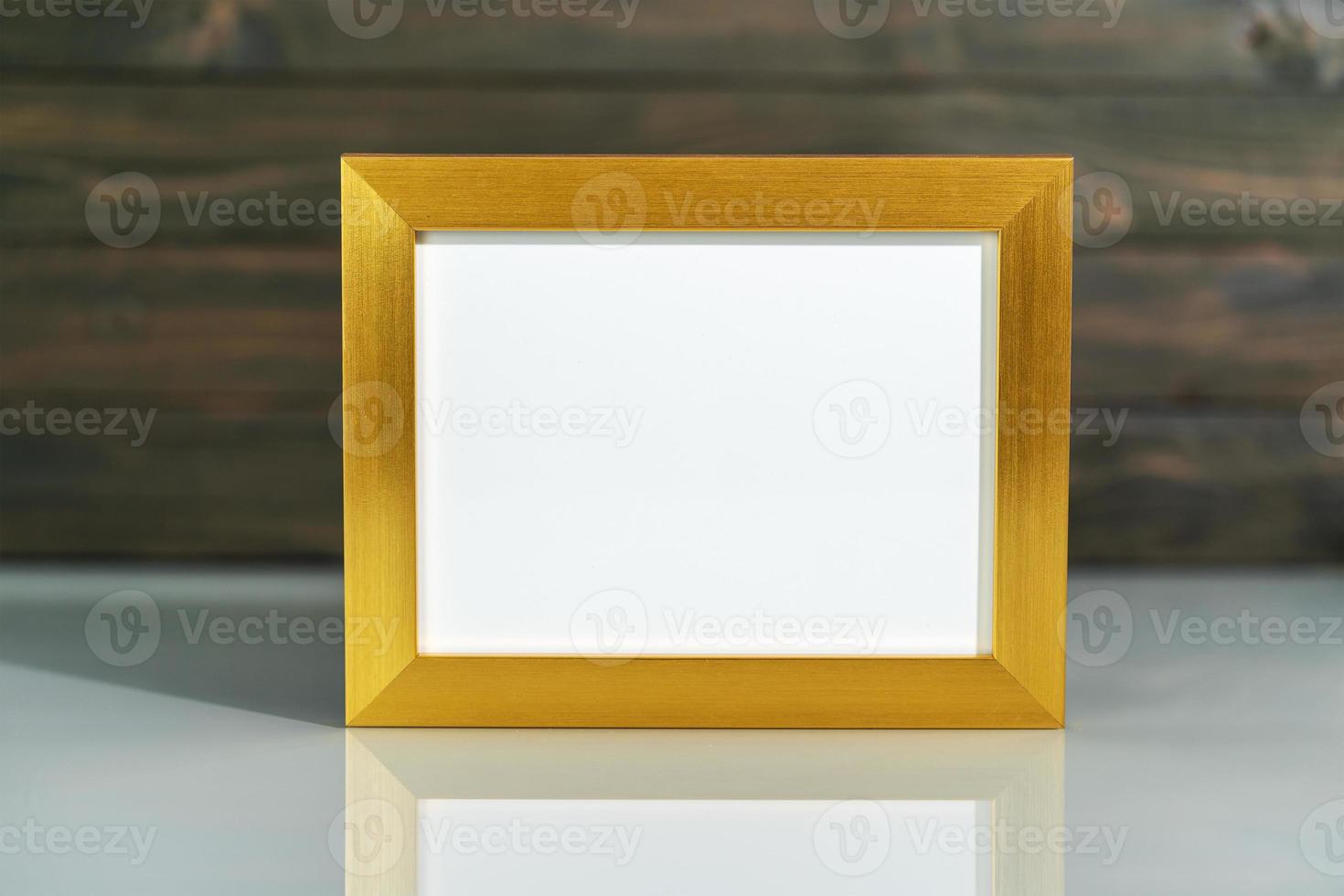 Picture golden frame mock up on table photo