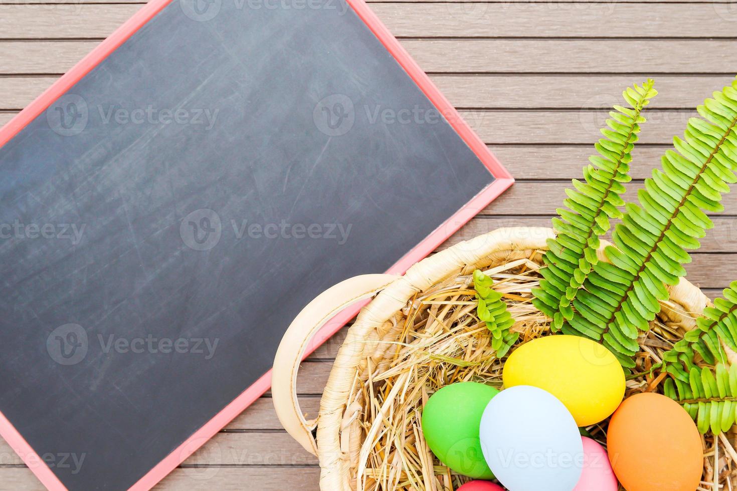 Easter eggs in basket and blackboard photo