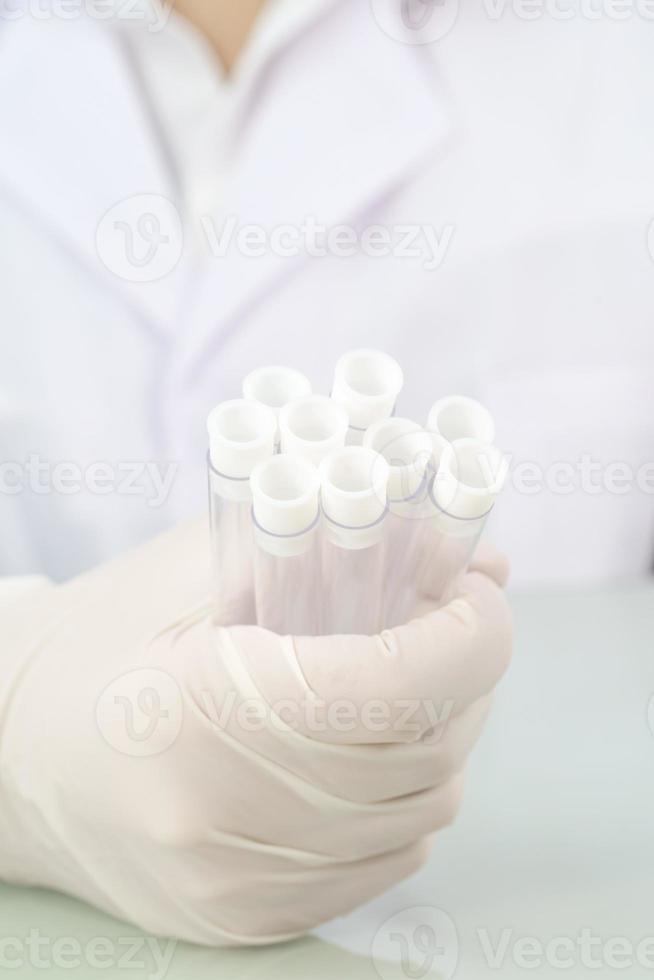 Scientist analyzing holding test tube in laboratory photo