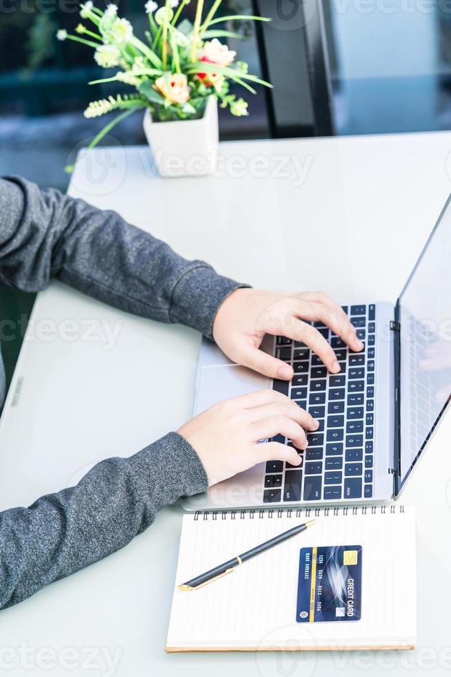 Woman using laptop payment credit card and for online shopping photo