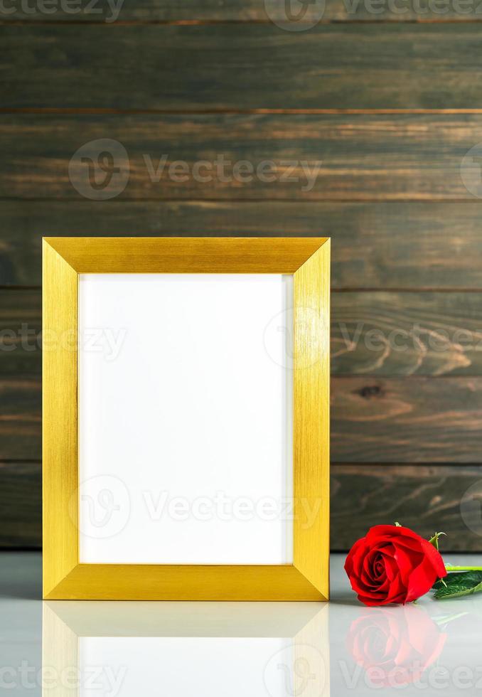 Picture mock up with golden frame on table with copy space photo