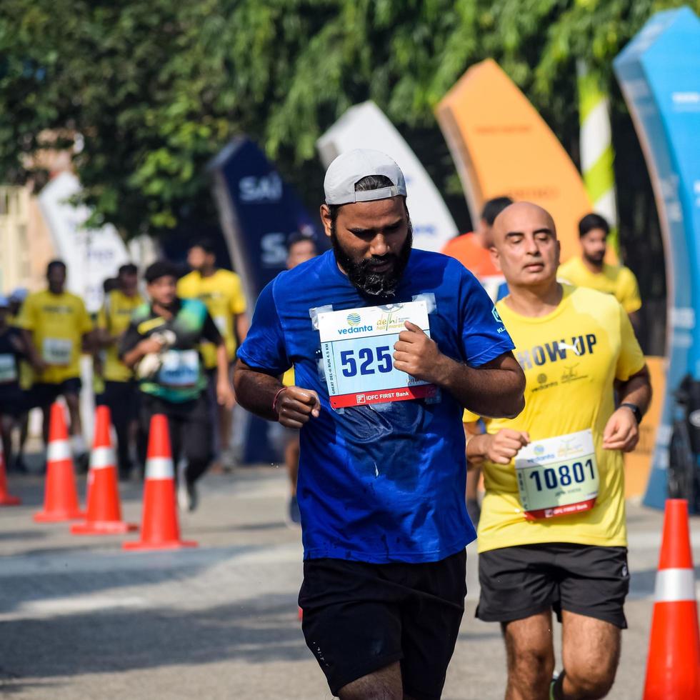 New Delhi, India - October 16 2022 - Vedanta Delhi Half Marathon race after covid in which marathon participants about to cross the finish line, Delhi Half Marathon 2022 photo