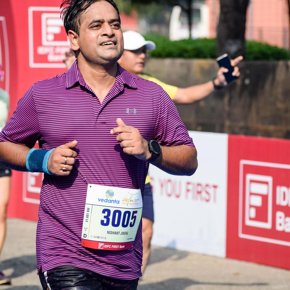 New Delhi, India - October 16 2022 - Vedanta Delhi Half Marathon race after covid in which marathon participants about to cross the finish line, Delhi Half Marathon 2022 photo