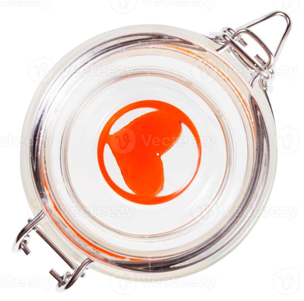 top view of red heart in closed glass jar isolated photo