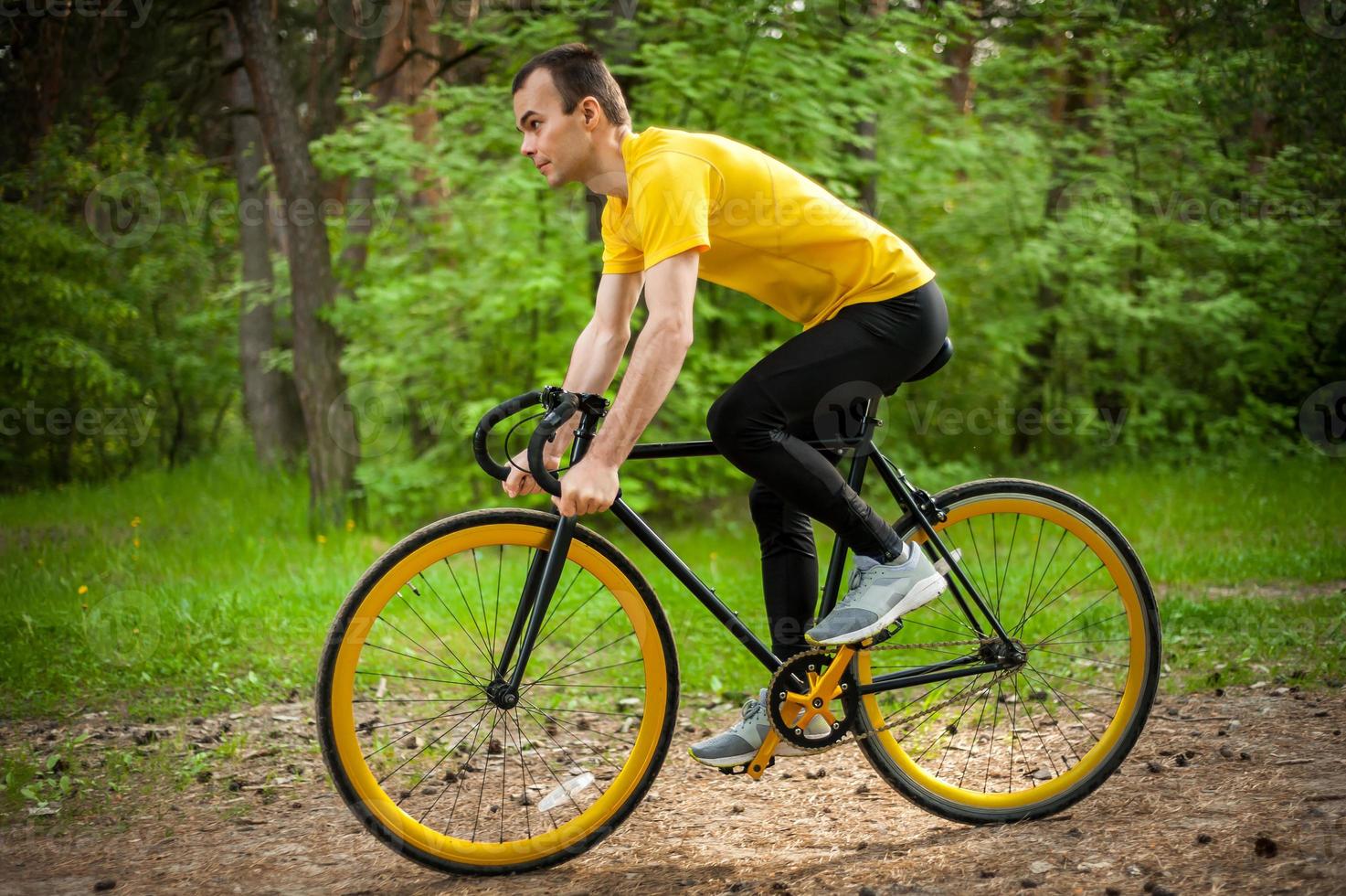 Portrait of a young man moving on a Bicycle. photo