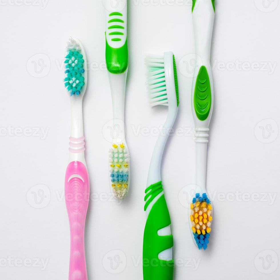 Various toothbrushes on a white background photo