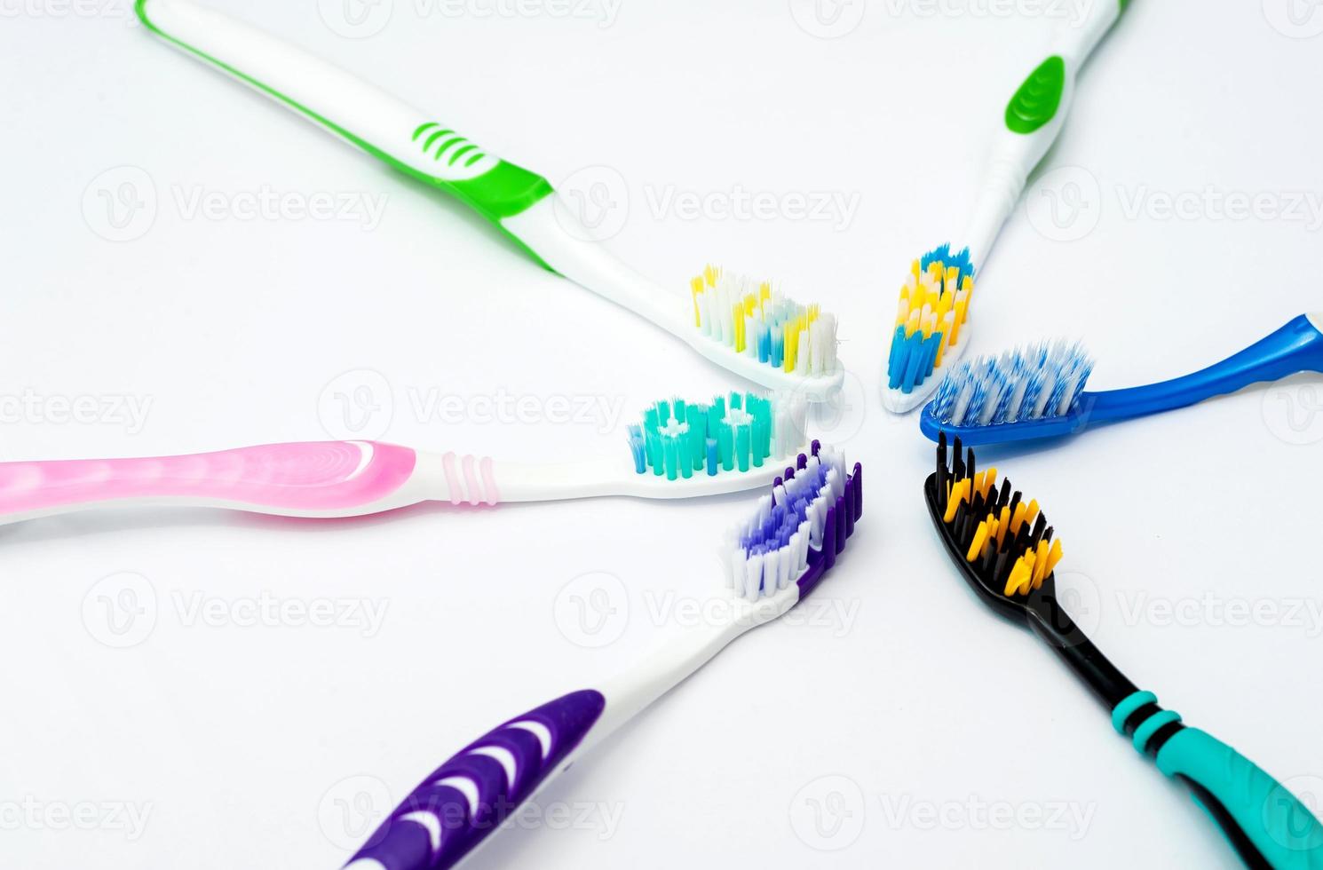 Various toothbrushes on a white background photo