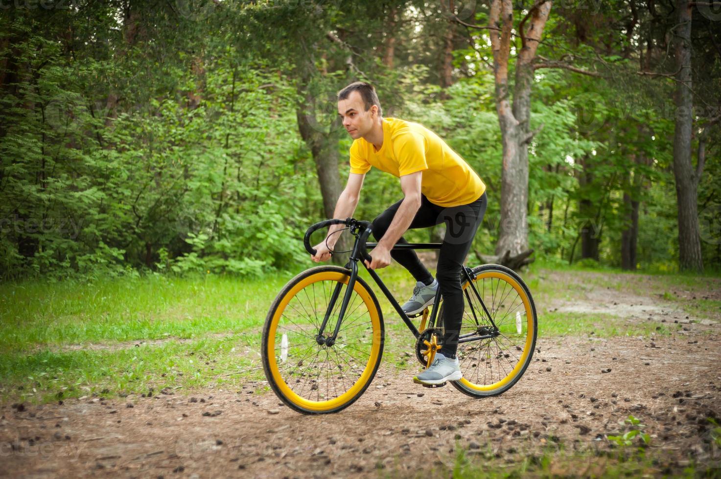 Portrait of a young man moving on a Bicycle. photo