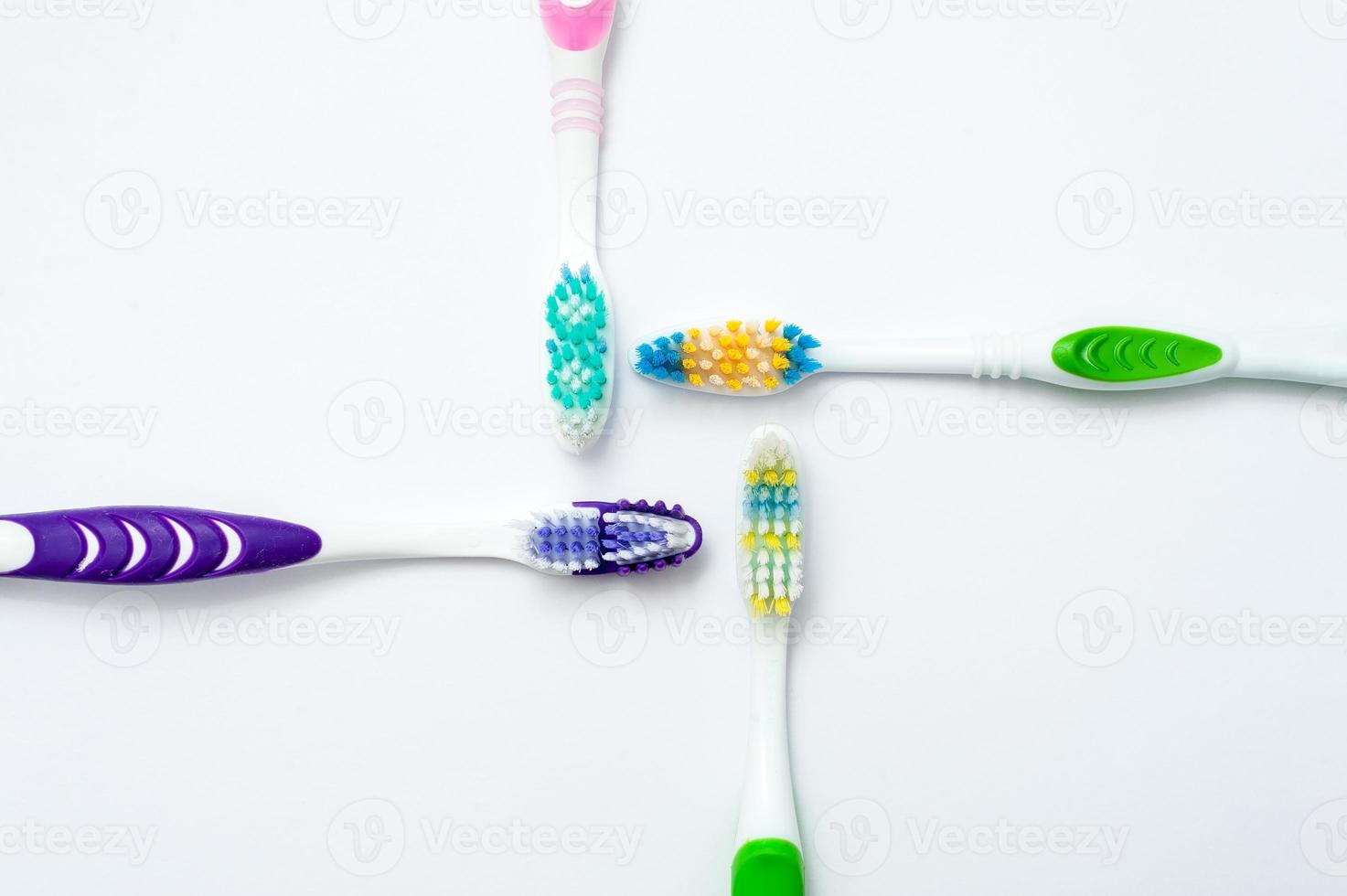 Various toothbrushes on a white background photo