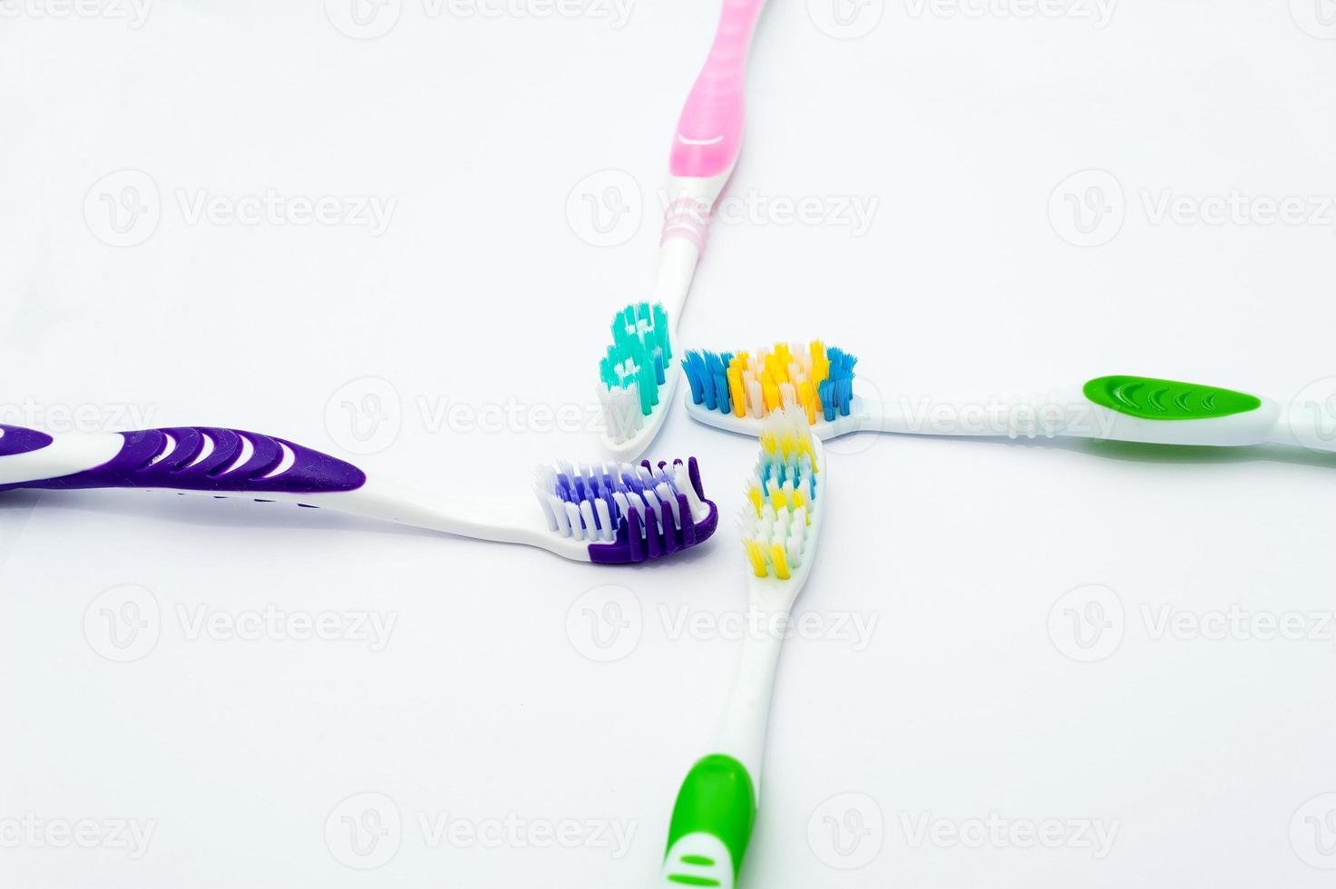 Various toothbrushes on a white background photo