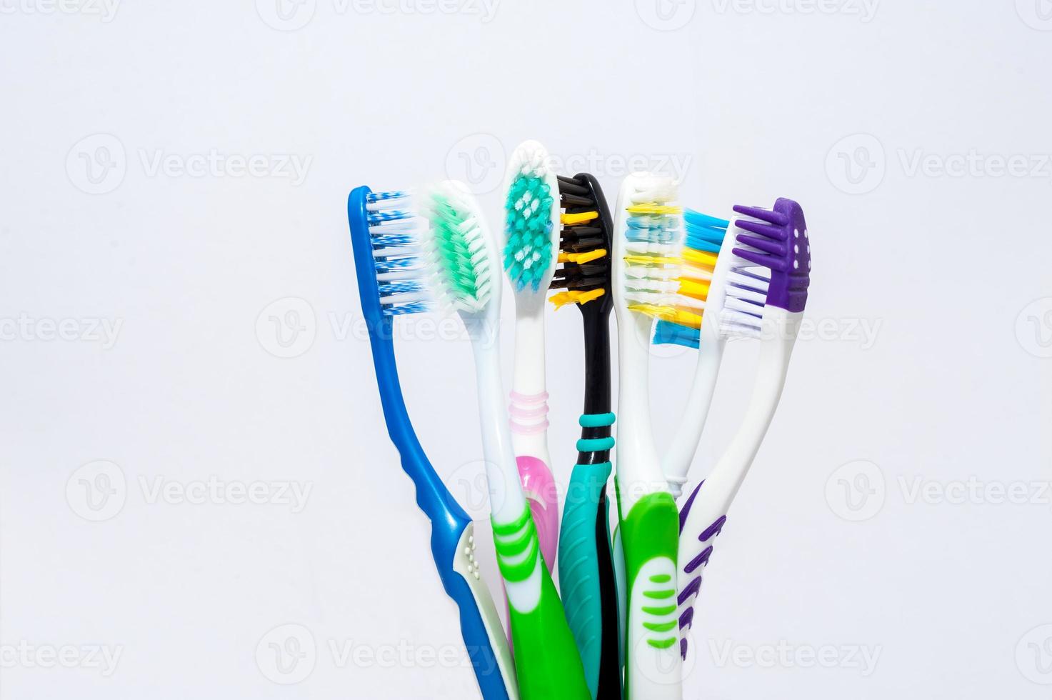 Various toothbrushes on a white background photo