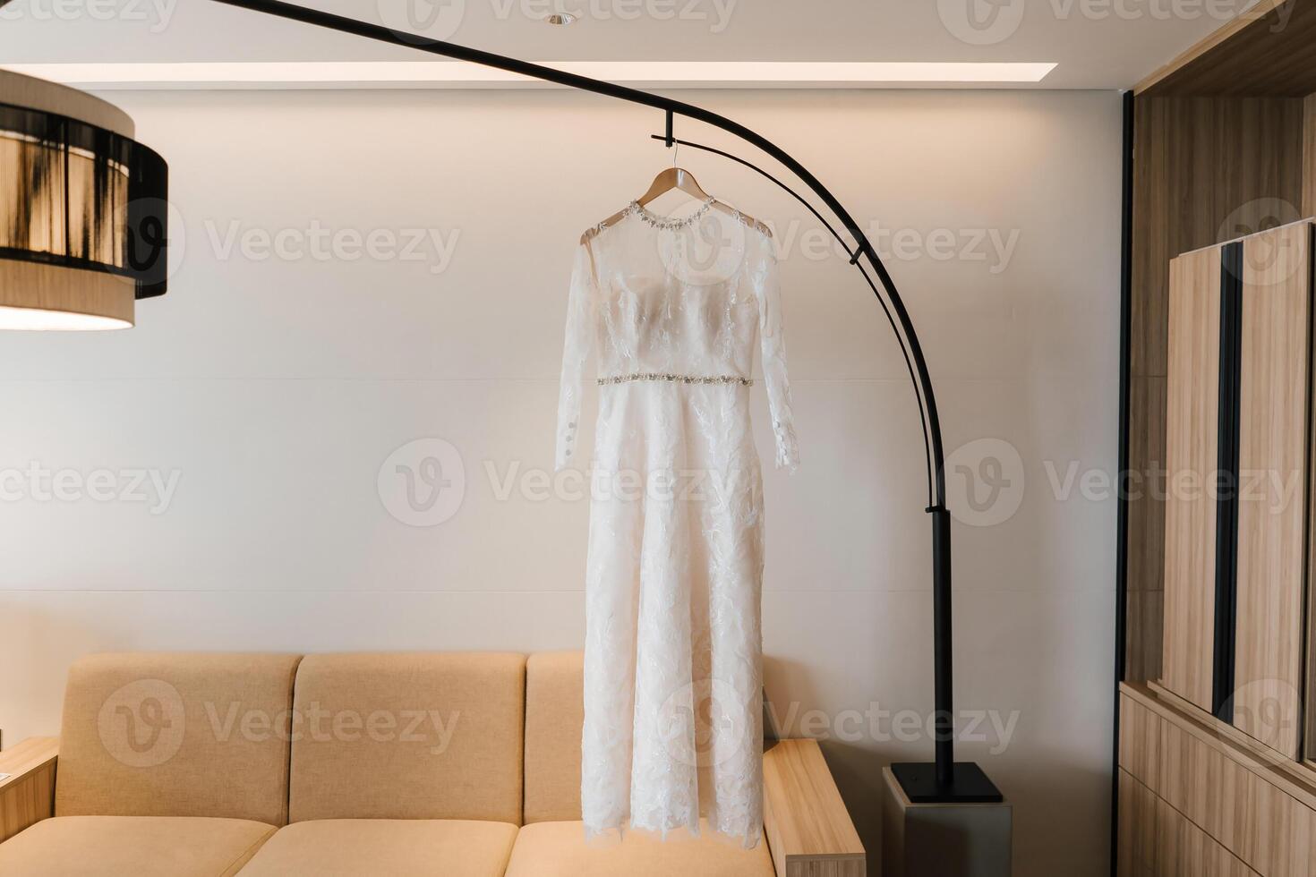 White gown or wedding dress hanging as a preparation for wedding. photo