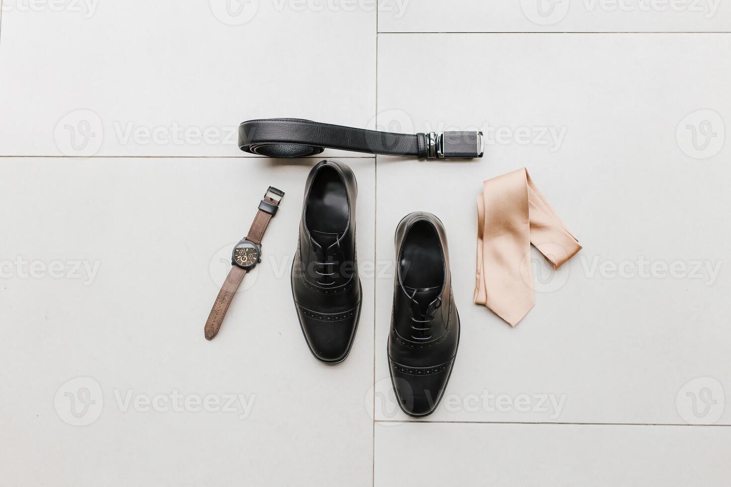 Detail presentation of a man watch, a pair of man shoes, ties and a belt, good for marketing material. photo