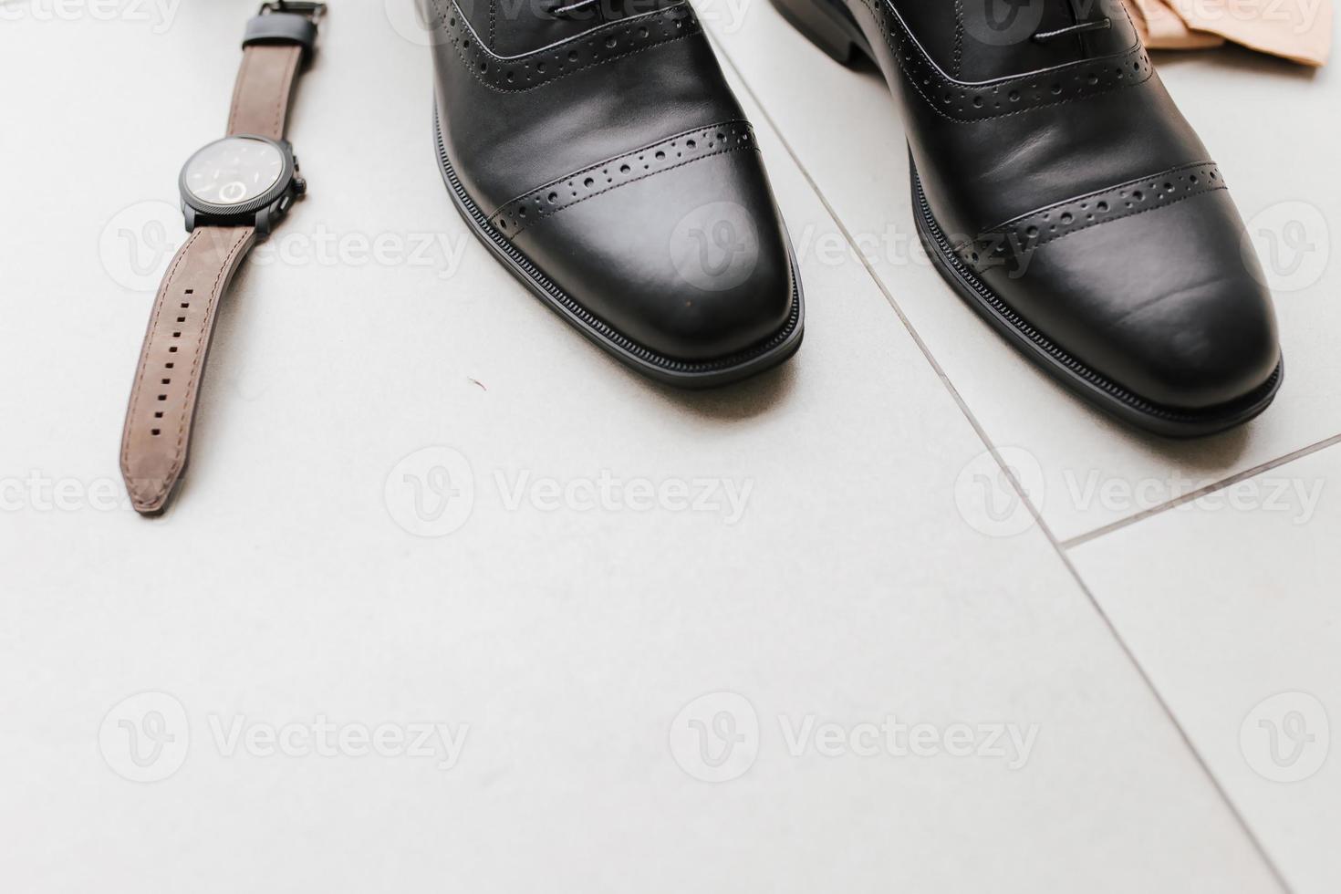 A pair of a executive man shoes and a brown watch with empty space. photo