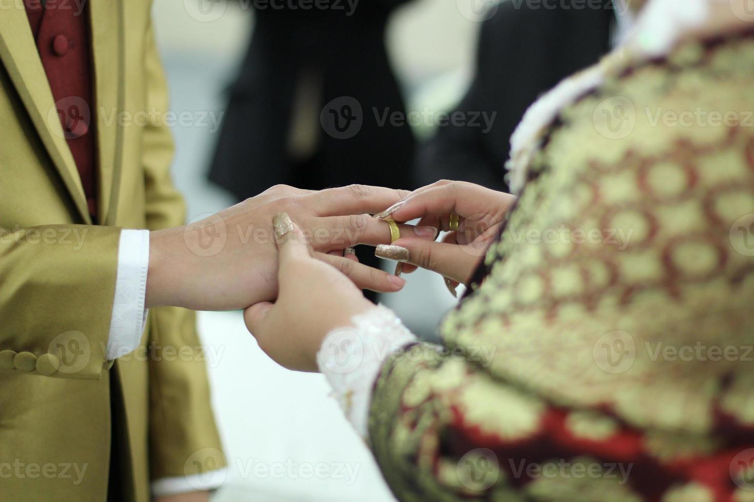 Sacred moment wedding ring exchange at the wedding ceremony before they become husband and wife. photo