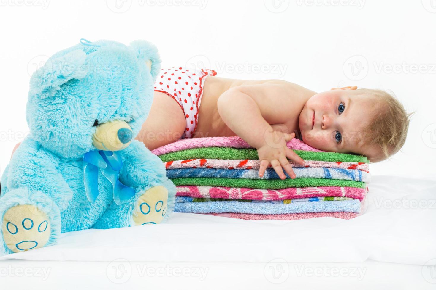 baby is on colourful towels photo