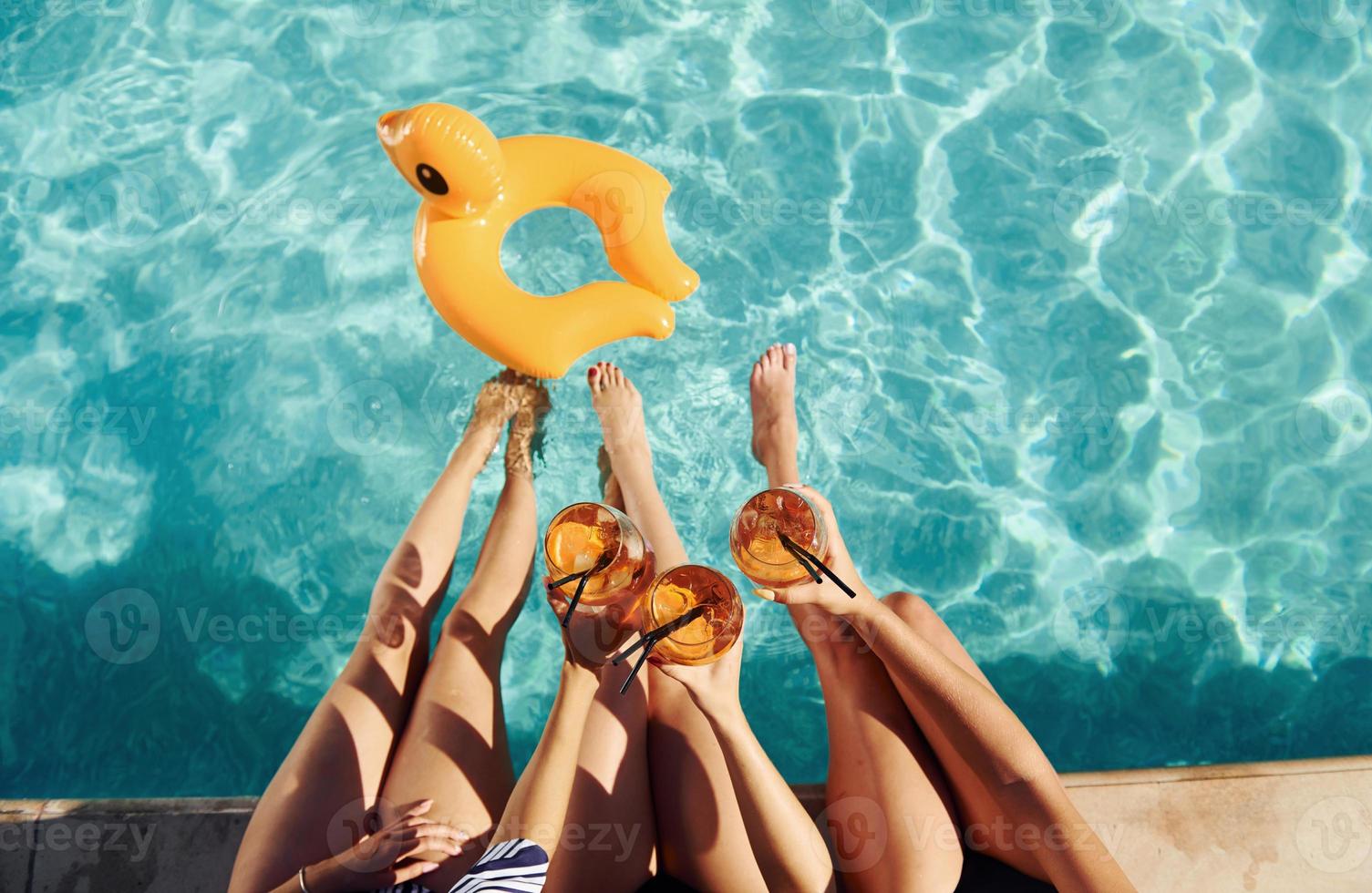 Top view of group of young happy people that have fun in swimming pool at daytime photo