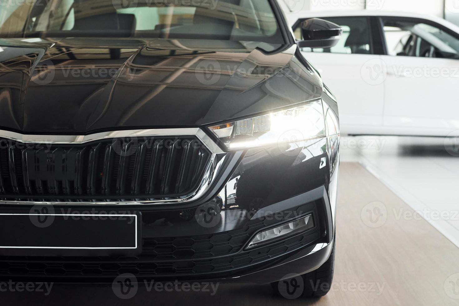 Headlight of car. Close up focused view of brand new modern black automobile photo