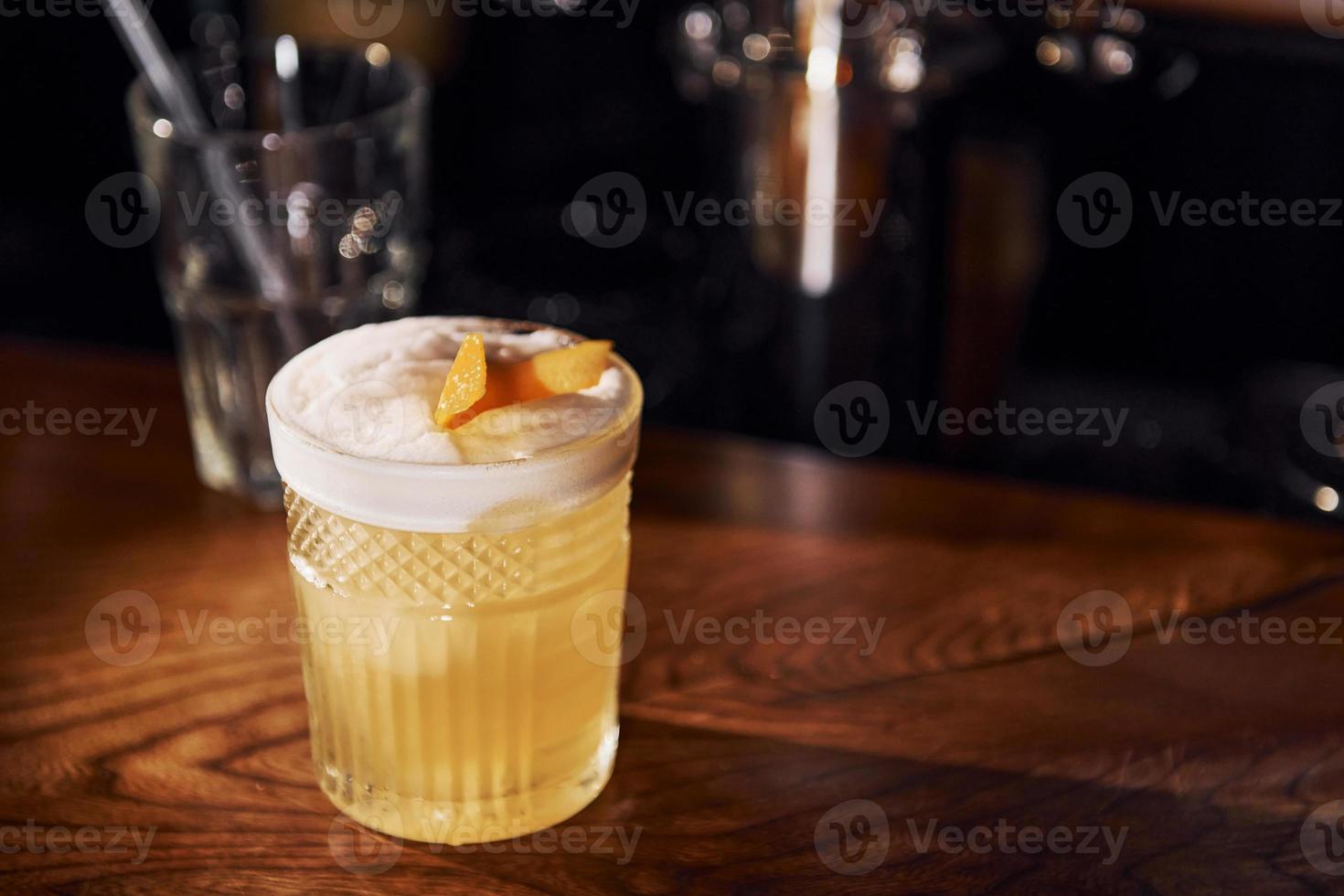 Ice cubes inside. Close up view of fresh summer cocktail on the wooden table photo