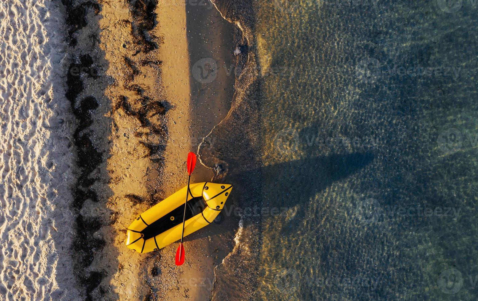 Top view of yellow boat that parked on the coast of ocean at daytime photo