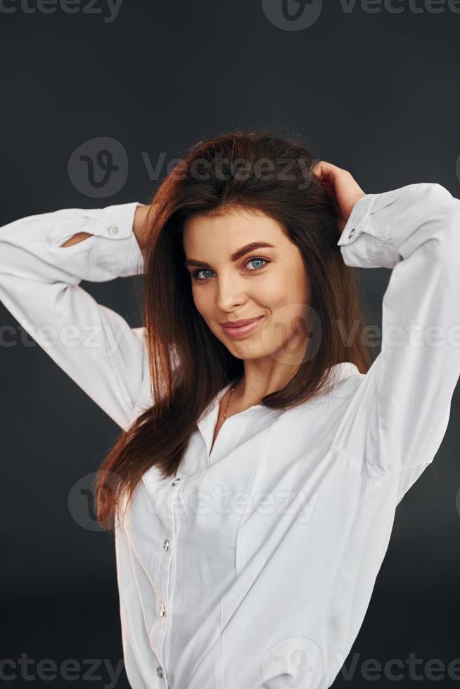 Young beautiful woman is posing for the camera in the studio photo