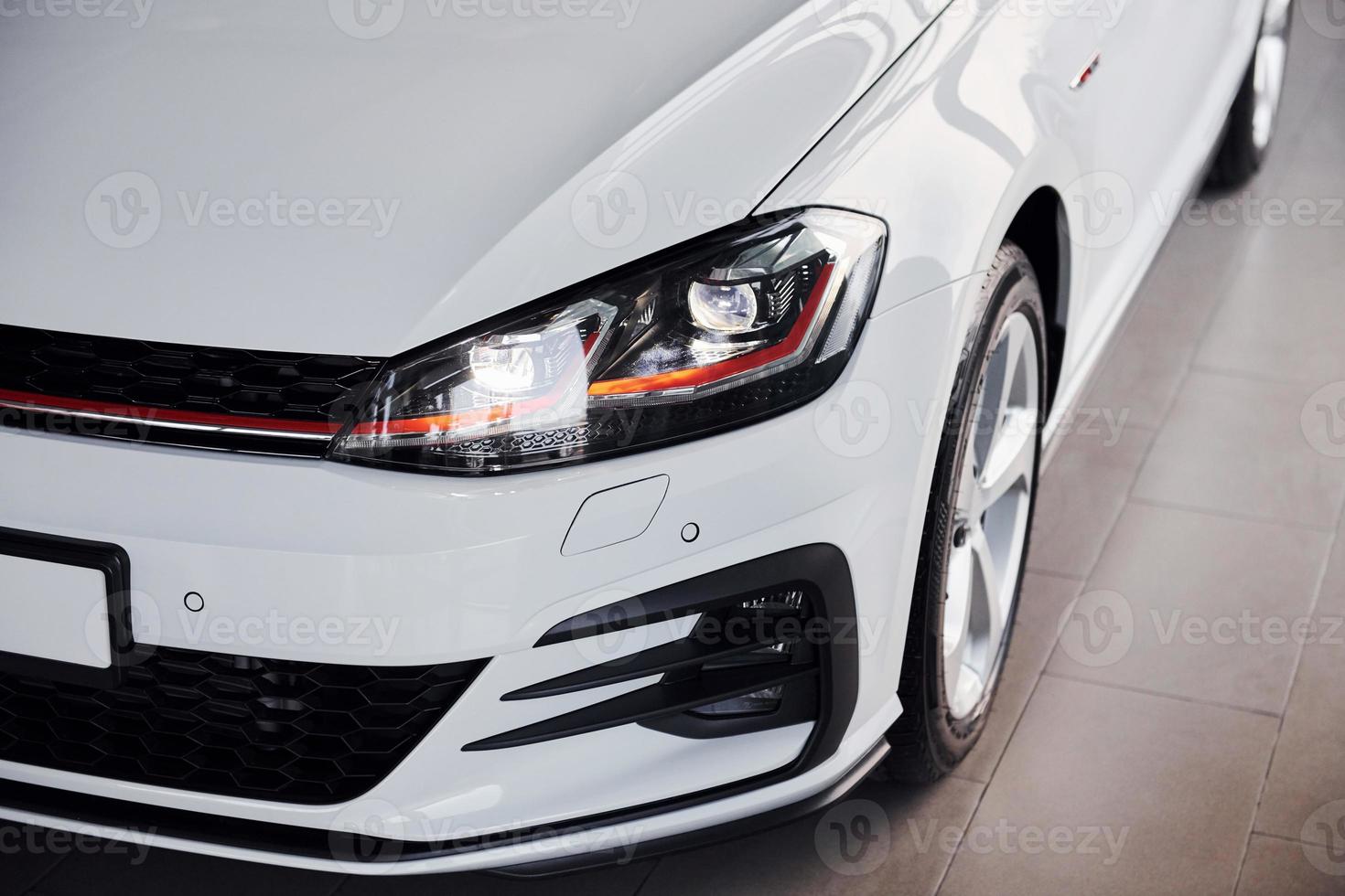Close up view of brand new white colored polished automobile photo