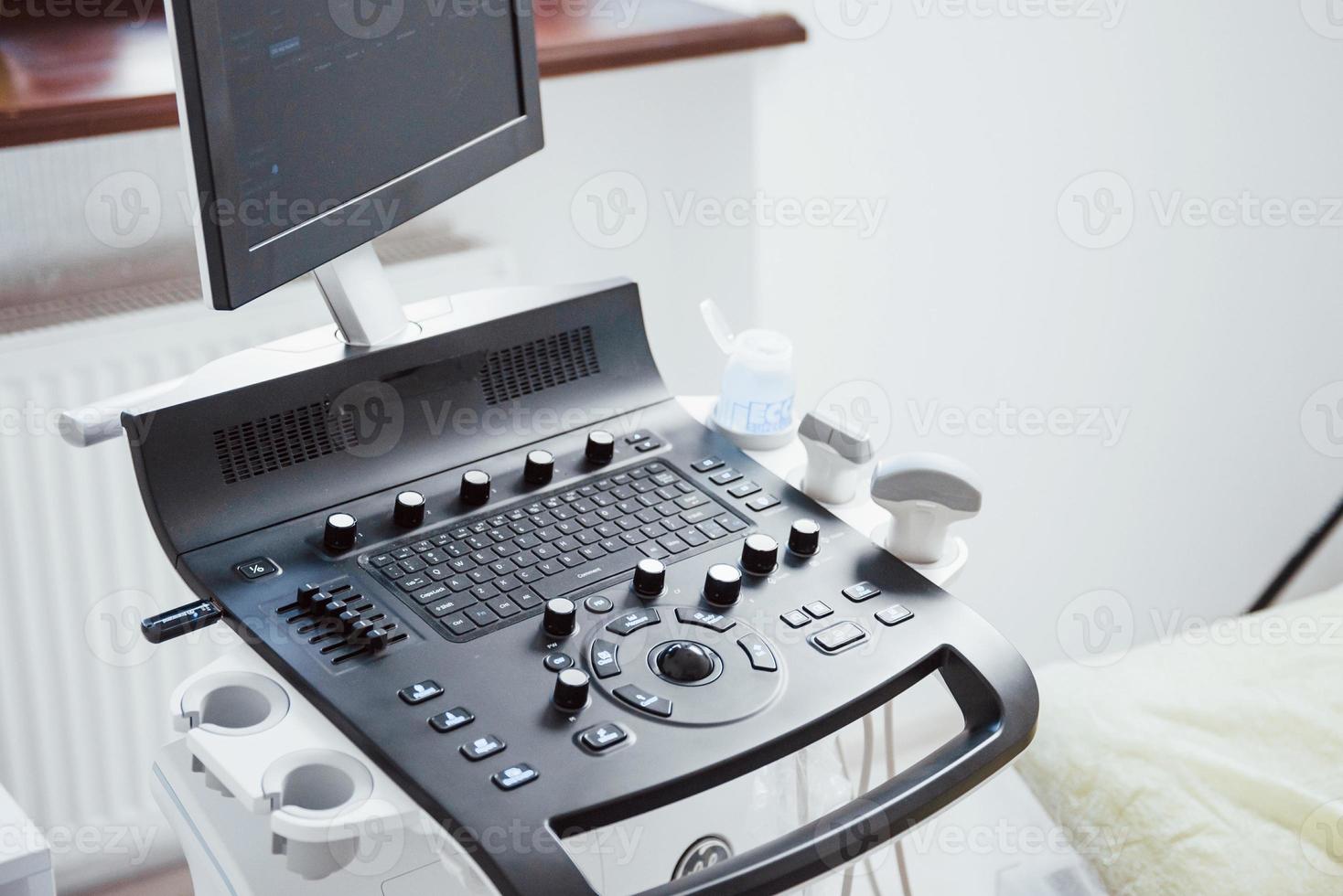 Close up view of control desk of ultrasound device in the clinic photo